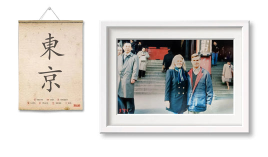 Wall art with Japanese character and framed photo of people in front of a building