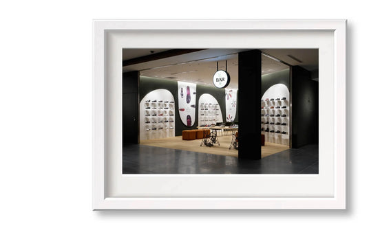 Interior view of a modern shoe boutique with numerous displayed shoes and stylish, contemporary design.