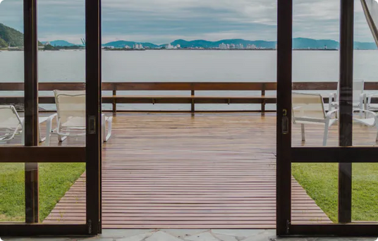 Cozy terrace with sea view, elegantly furnished room with curtains and seating