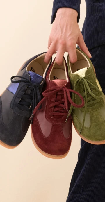 Woman holding sneaker in hand