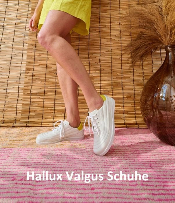 Woman wearing white hallux valgus shoes in front of a bamboo wall